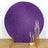 Purple glitter backdrop with gold candle holders.