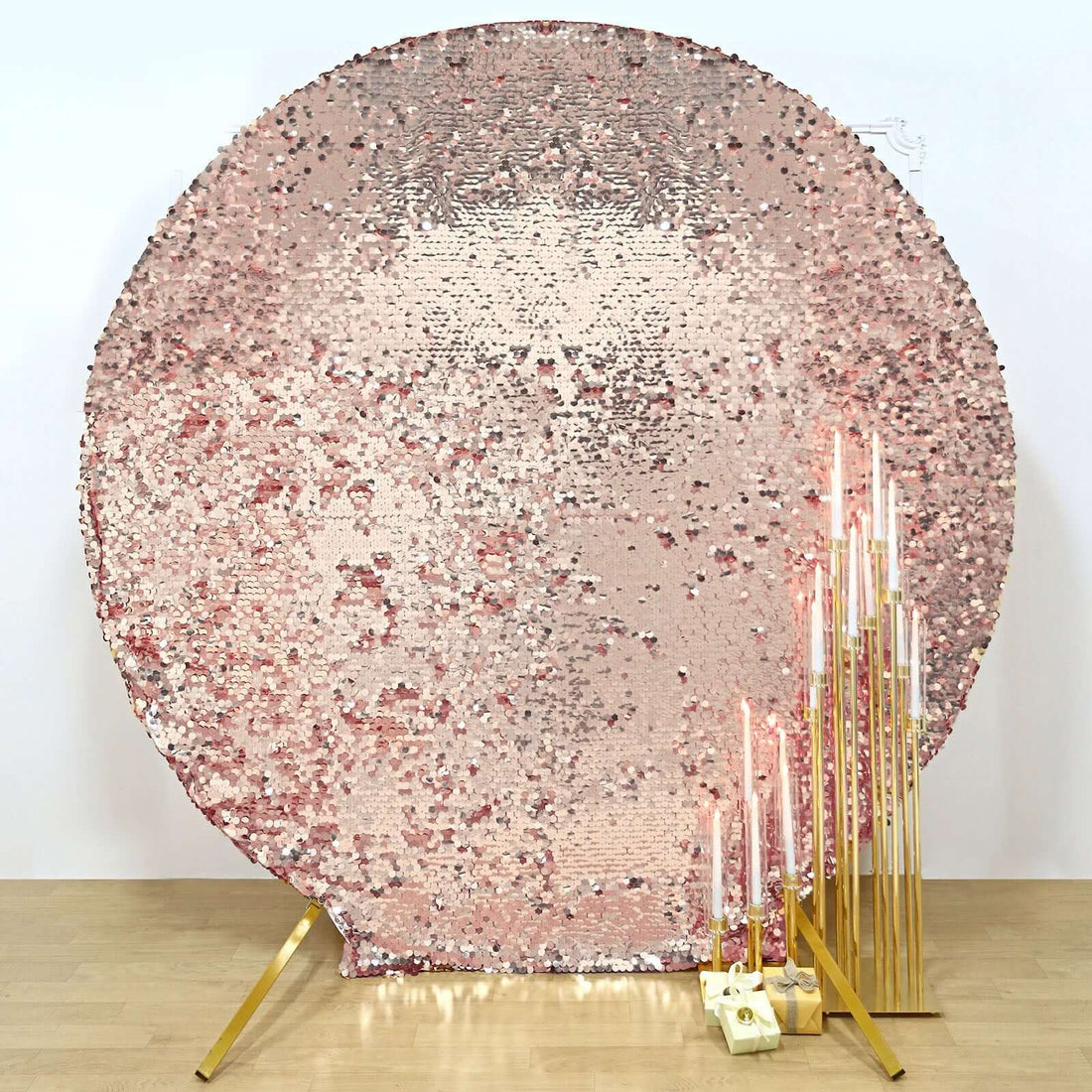 Rose gold sequin backdrop with gold candle holders and candles