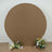 Round brown backdrop with floral arrangements on either side.