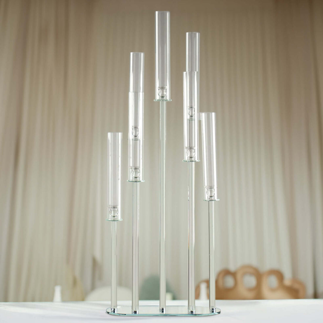 Clear glass candle holder with multiple tubes in a modern design.