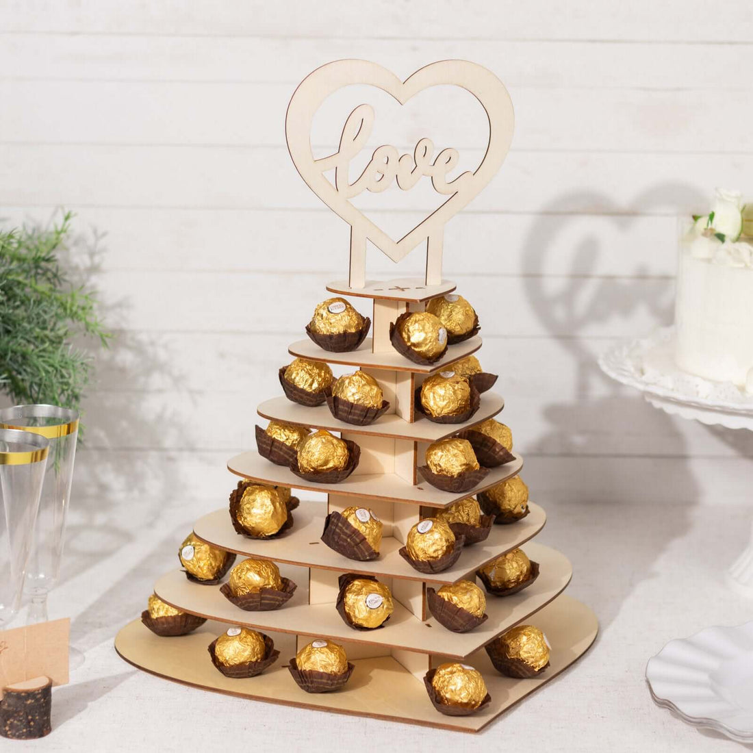 Wooden dessert stand with Ferrero Rocher chocolates for celebrations.