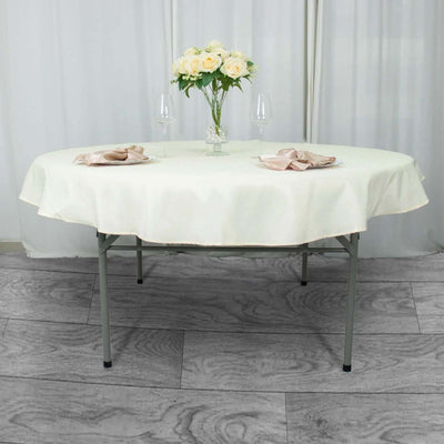 Round folding table set for dining with floral centerpiece and elegant tableware.