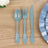 Blue plastic cutlery set on wooden table.