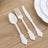 Elegant white plastic cutlery set on wooden table