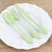 Pastel green cutlery set on a white plate.
