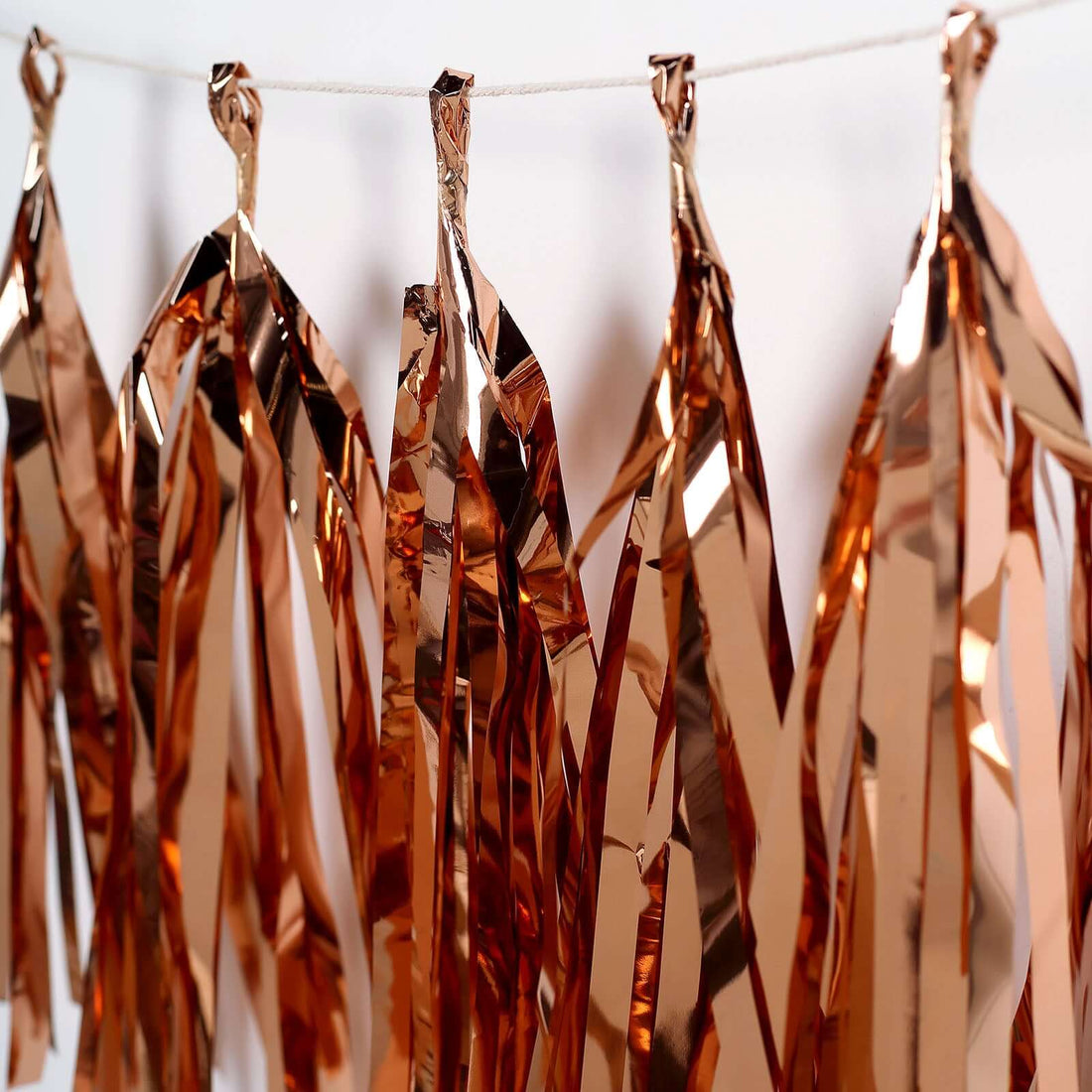 Copper foil party streamers hanging in a row.