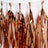 Copper foil party streamers hanging in a row.