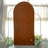 Brown arched backdrop with floral decorations in a studio setting