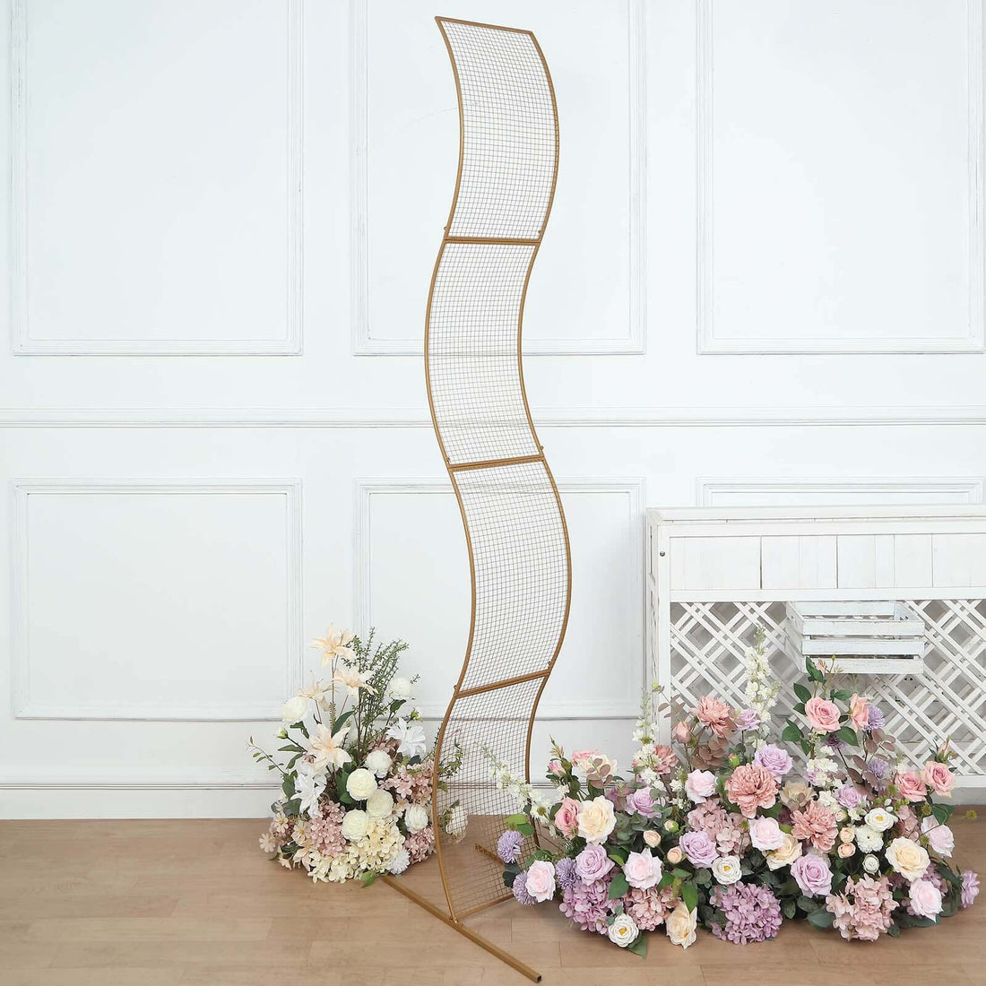 Gold curved display stand with floral arrangements