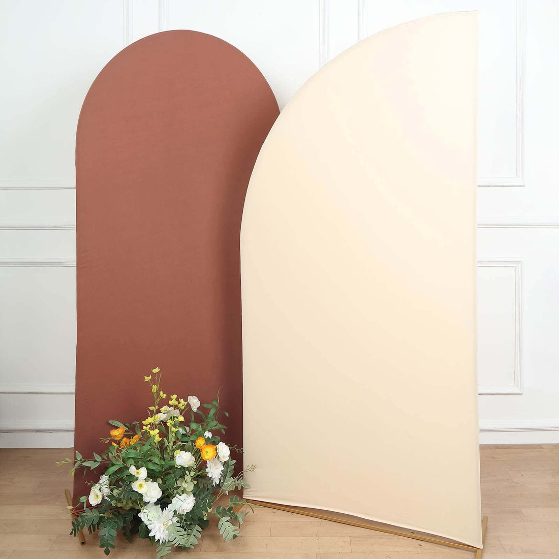 Brown and cream arch backdrop with floral arrangement at the base