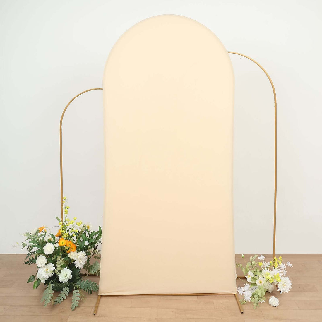 Neutral beige backdrop with gold frame and floral arrangements