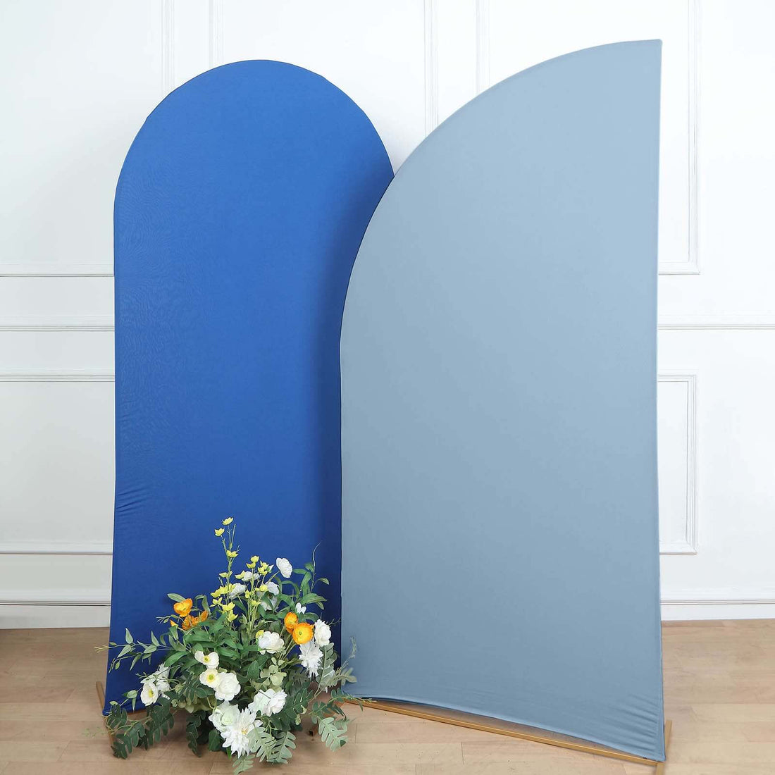 Two curved fabric backdrops in blue and gray with a floral arrangement at the base.
