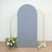 Gray backdrop with gold frame and floral arrangements at the base.