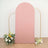 Pink backdrop with gold frame and floral arrangements