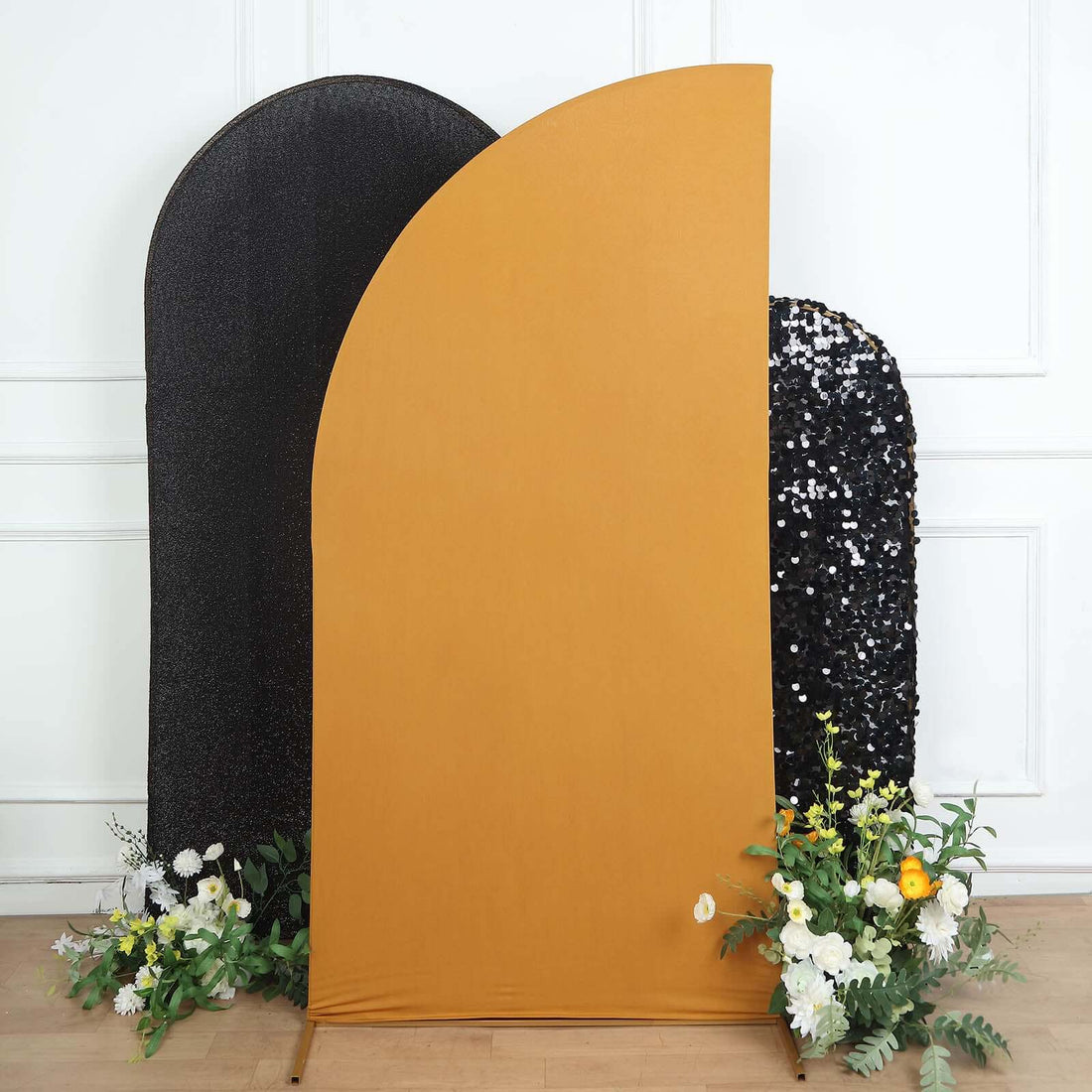 Mustard yellow backdrop with decorative flowers and sequined black screen.