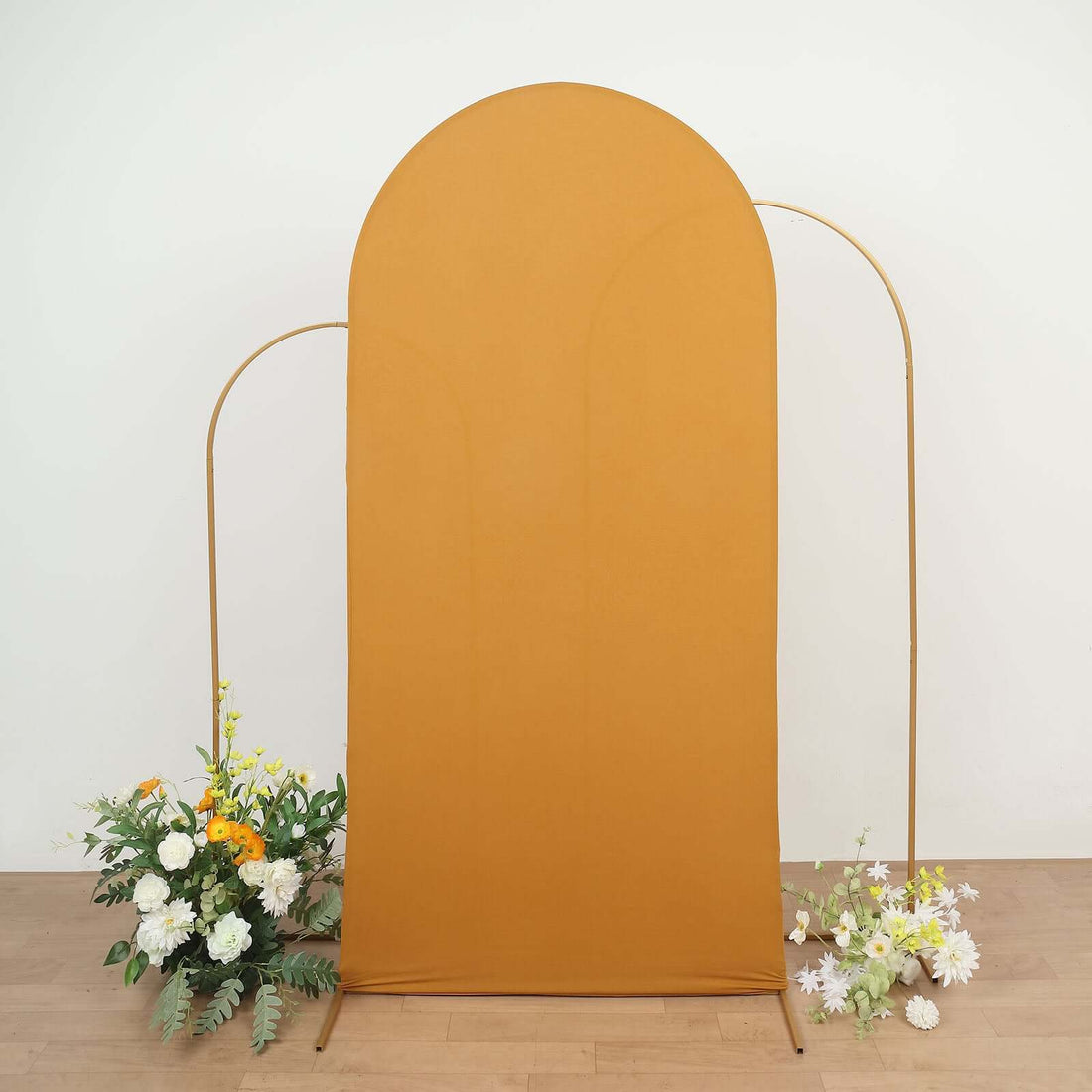 Mustard arch backdrop with floral accents for photography.