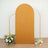 Mustard arch backdrop with floral accents for photography.