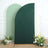 Green and white backdrop with floral arrangement in studio setting.