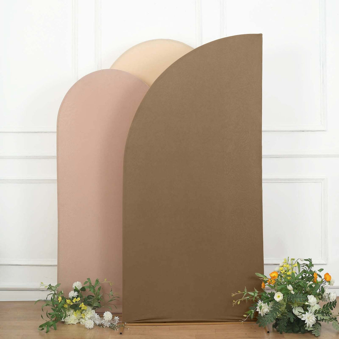 Colorful curved backdrops with flowers in a staged setting.