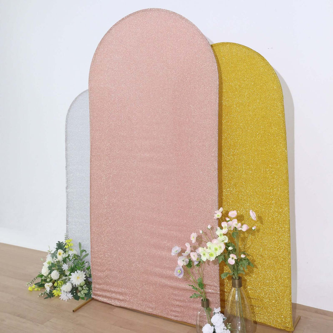 Glitter backdrop panels in pink, gold, and silver with floral accents