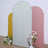 Three glittery backdrop panels in gold, silver, and pink, with flowers in front.
