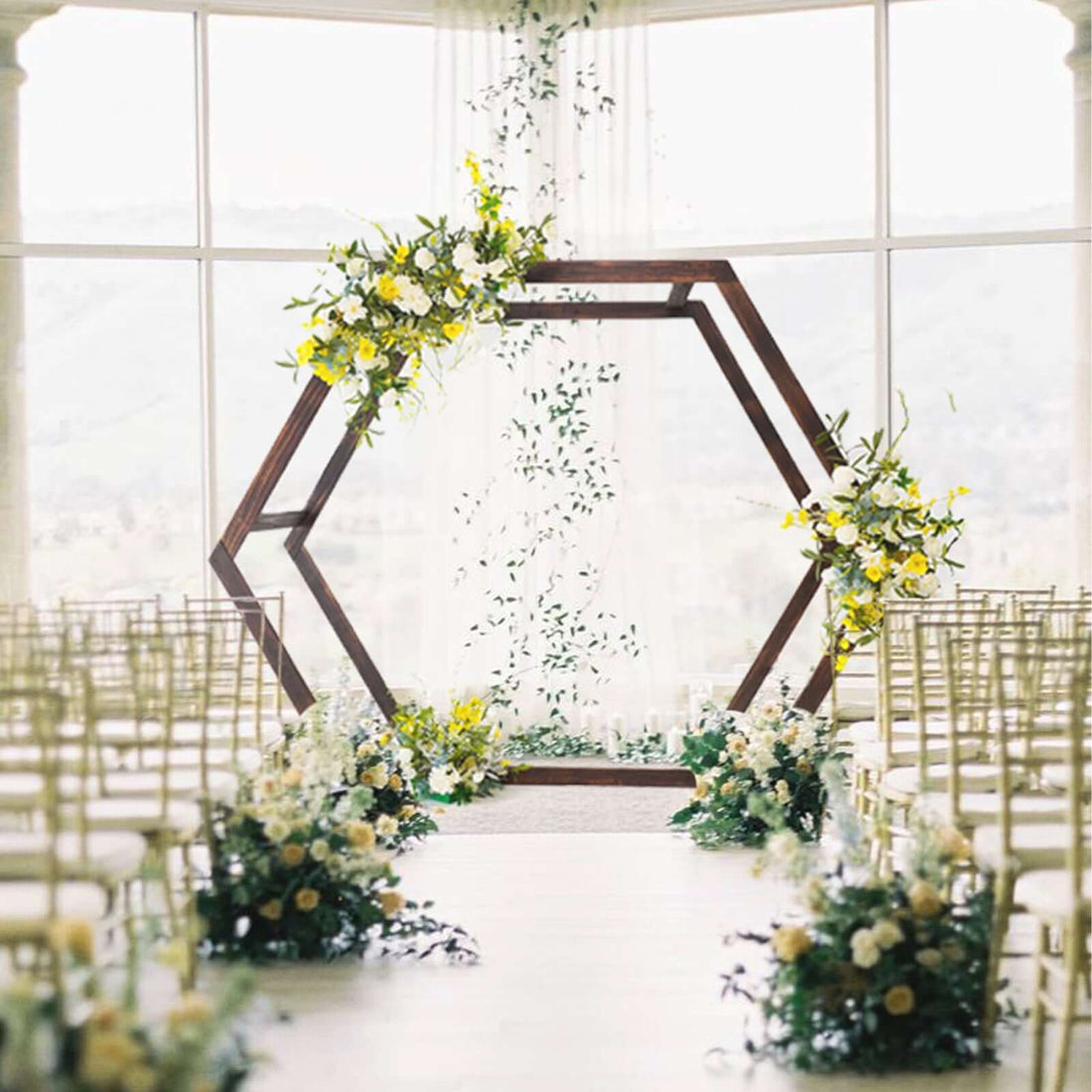 Wedding ceremony setup with floral decorations and a wooden arch.