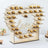 Heart-shaped dessert display stand with gold treats for weddings or events.