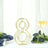 Gold number 8 table centerpiece with wine glass and greenery