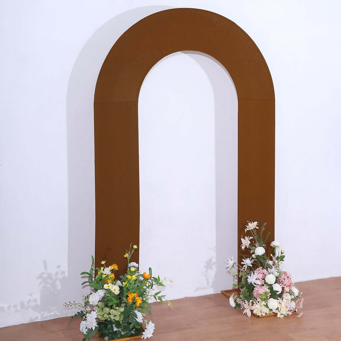 Brown arch with floral arrangements on either side