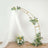 Gold arch with white drapery and floral arrangement, ideal for events or weddings.