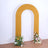 Yellow arch with floral arrangements on either side
