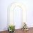 White floral arch with vibrant flowers at the base