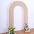 Beige arch backdrop with floral arrangements for events or photography.