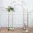 Gold wedding arch with floral arrangements on a plain backdrop.