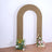 Decorative arch with floral arrangements on each side.
