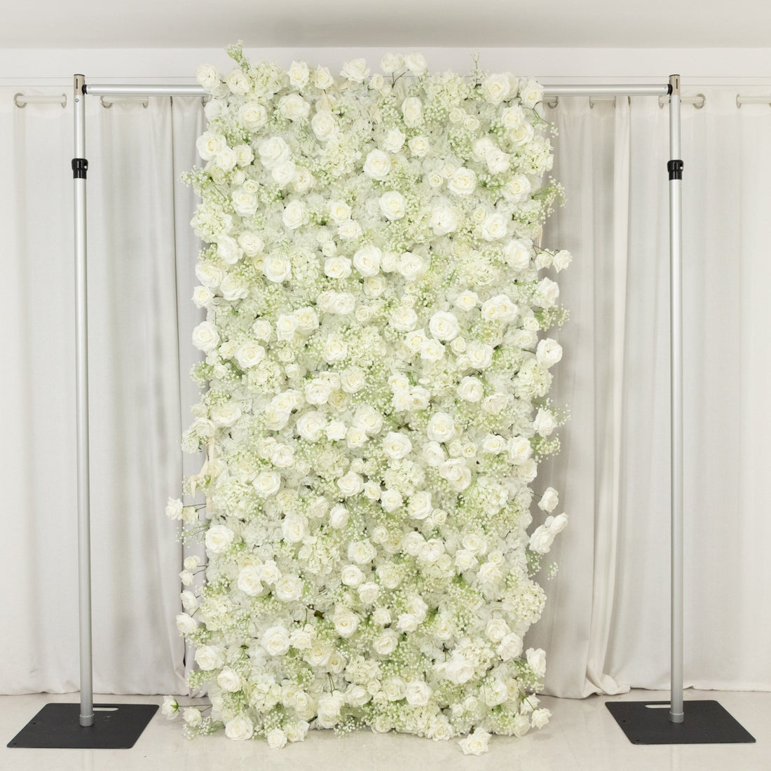 White floral backdrop with roses for events or photo shoots.