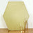 Hexagon-shaped glitter backdrop with gold accents and candle holders.