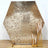 Gold hexagon sequin backdrop with elegant candle holders in front.