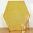 Hexagon-shaped gold glitter backdrop with gold candle holders.