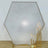 Hexagonal glass backdrop with gold candle holders and candles