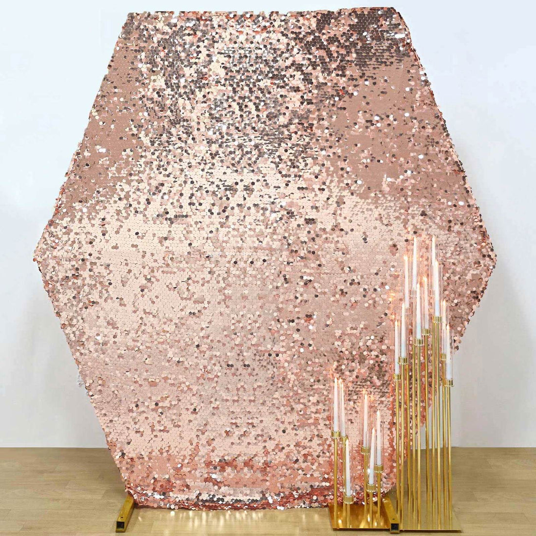 Rose gold sequin backdrop with gold candle holders