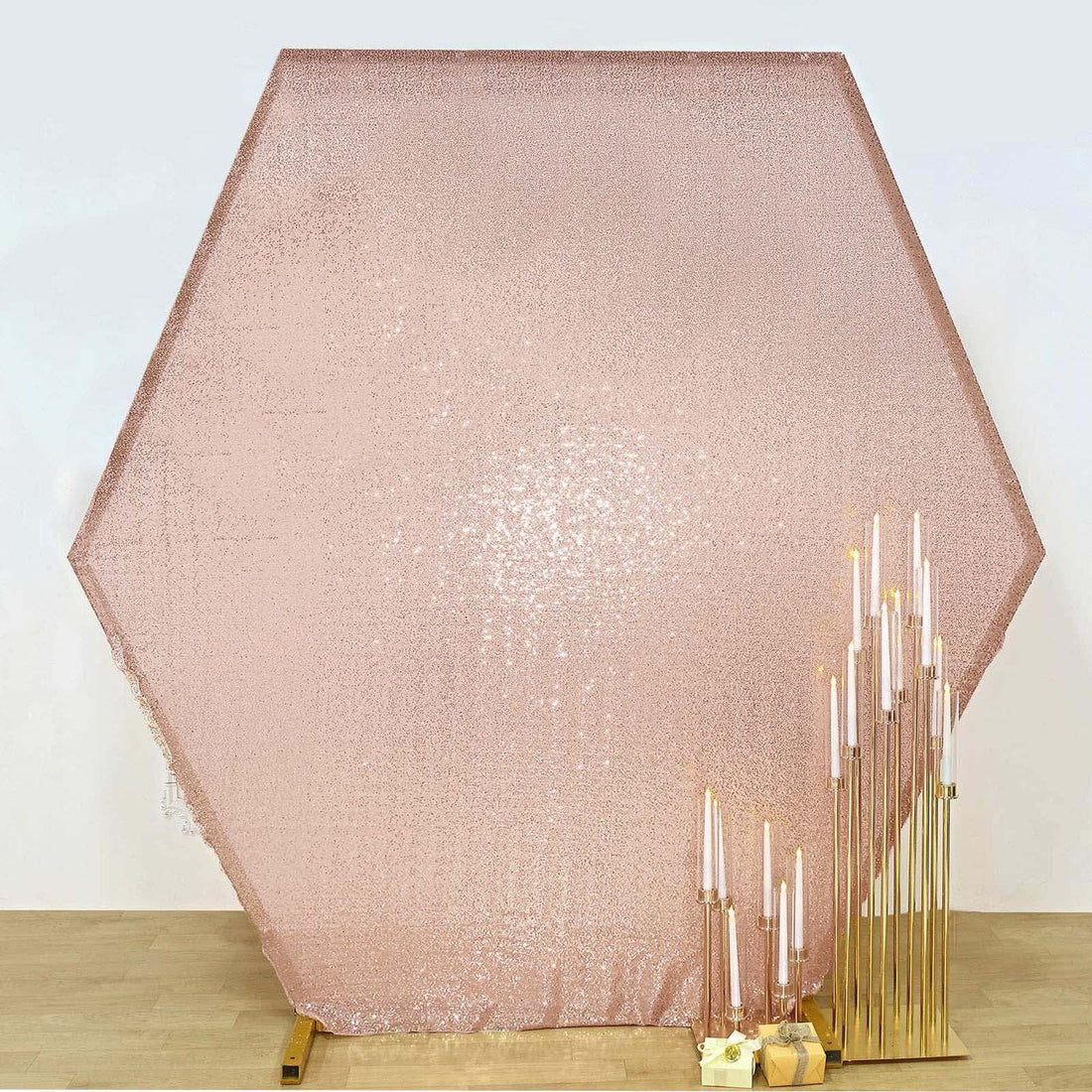 Hexagon sequin backdrop in rose gold with gold candle holders.