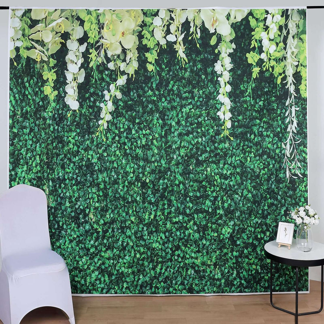 Artificial greenery backdrop with flowers for decoration and photography.