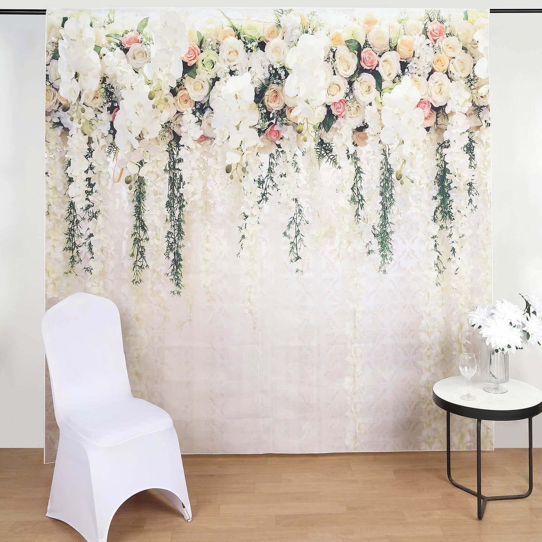 Elegant floral backdrop with white chair and table for events and photography.