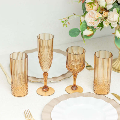 Elegant amber glassware set on a dining table with floral arrangement.