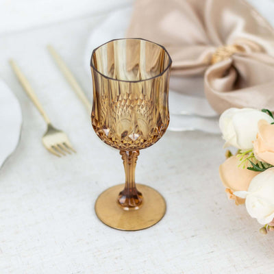 Elegant amber glass goblet on a table setting with floral accents.
