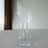 Modern glass sculpture with cylindrical tubes on a mirrored base.