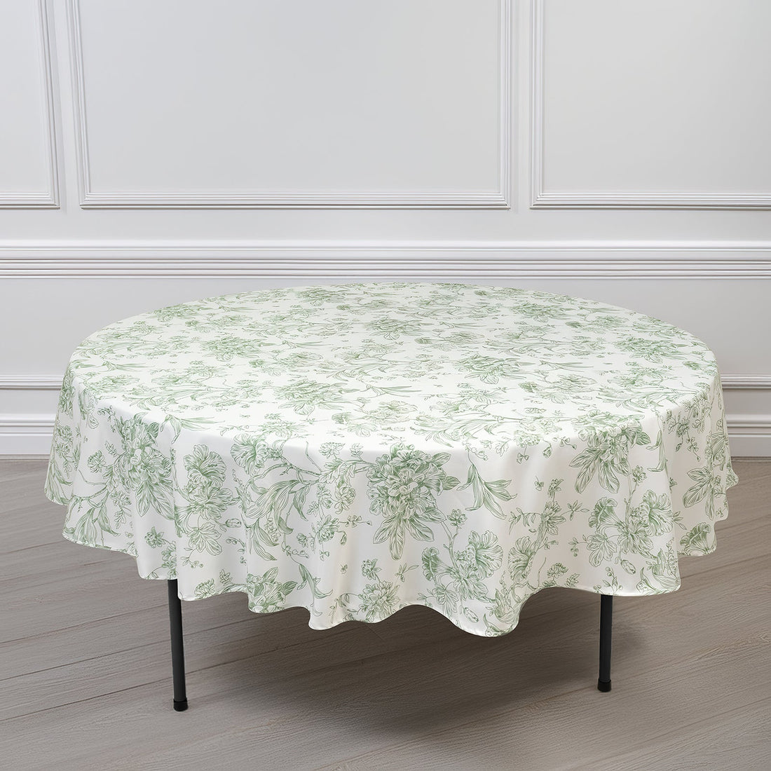 Round floral tablecloth with green pattern on a white background.