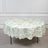 Round floral tablecloth with green pattern on a white background.