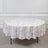 Round floral tablecloth in lavender on a plain backdrop.